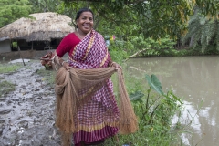A woman fish farmer catching fish in Khulna, Bangladesh. Photo by Yousuf Tushar. July 28, 2015