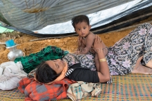 PALONGKHALI, UKHYA, COX’S BAZAR, BANGLADESH- SEPTEMBER 26, 2017: Rohingya children wait for food aid near the Thengkhali makeshift camp in Cox’s bazar, Bangladesh. Thousands of Rohingyas still crossing the border between Myanmar and Bangladesh after the Burmese army started an operation against the Rohingyas, by burning and destroying their home in the Rakhine state of Myanmar, as now more than 410,000 Rohingyas crossed the border and the United Nations expect the number rises to 1 million by the end of the year.